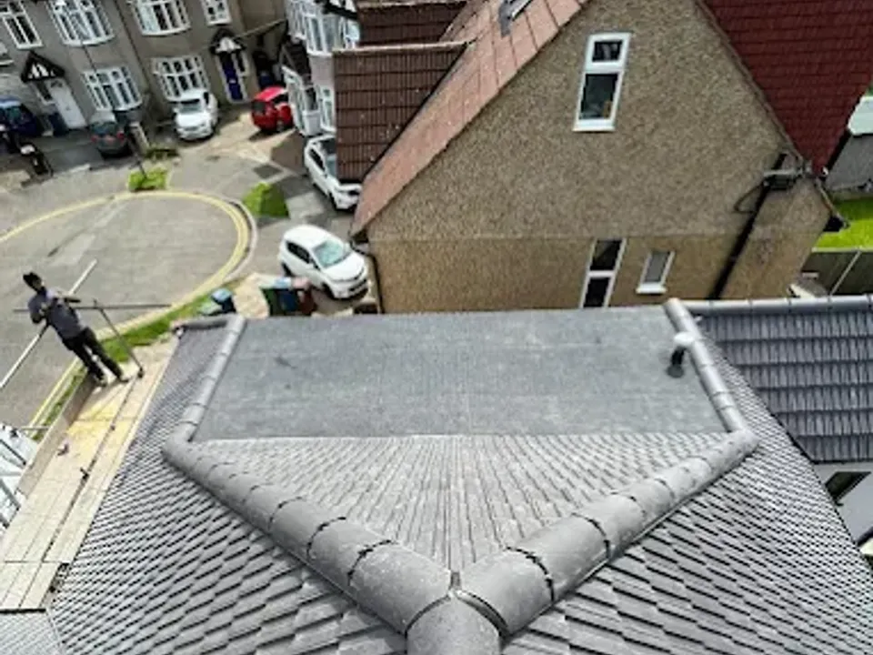 Close-up of a neatly finished grey tiled hip and valley junction