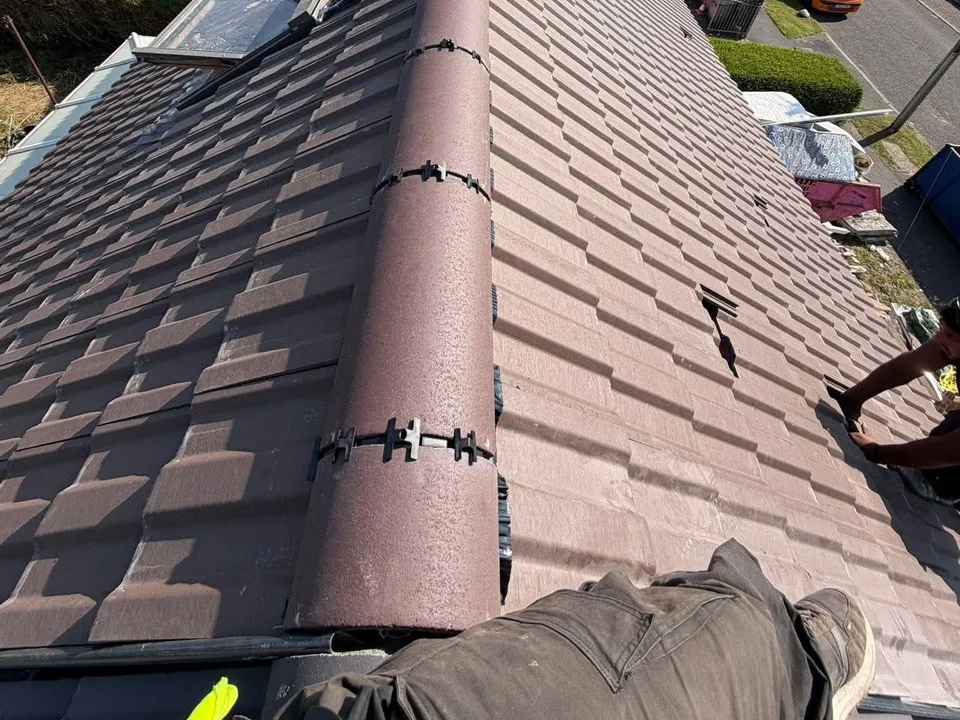 View along a new grey roof ridge over a residential street