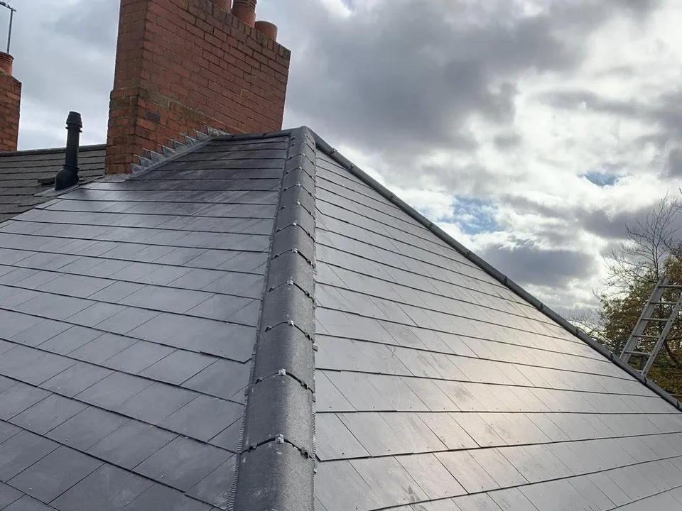 New grey slate hipped roof with bedded ridge tiles