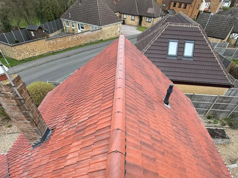 A finished red tiled hipped roof