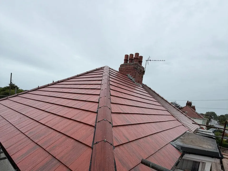 Red tiled roof and chimney on a terraced house