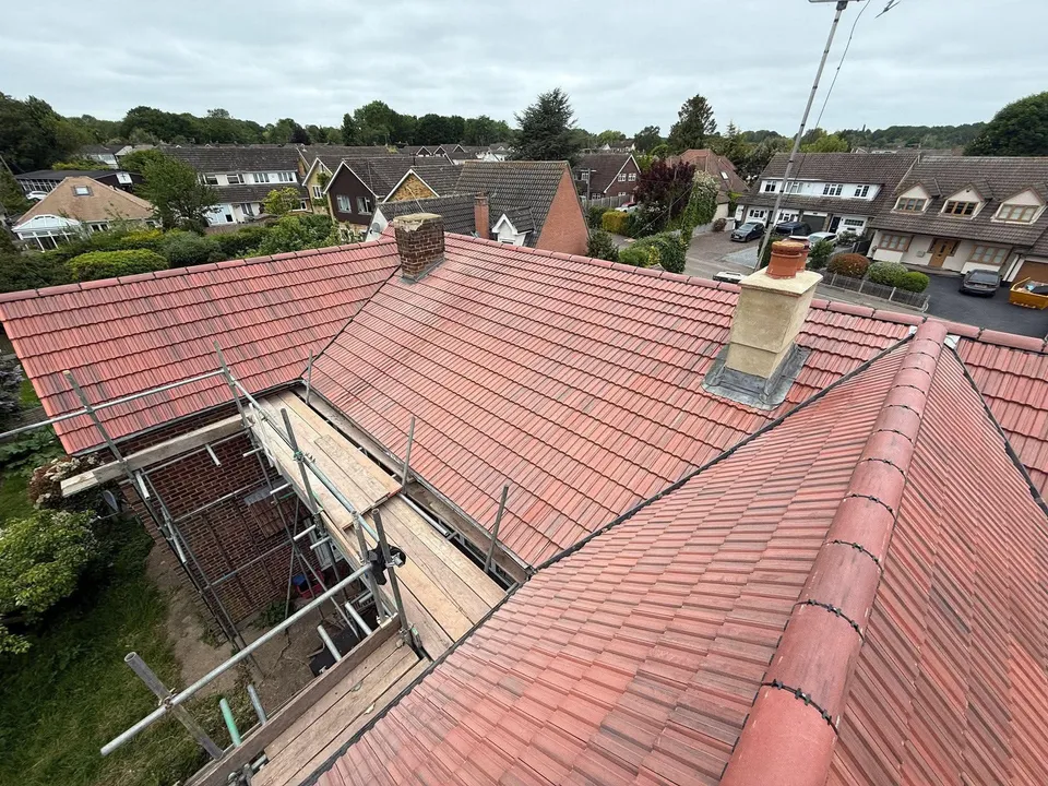 Rows of newly tiled red roofs across a neighbourhood