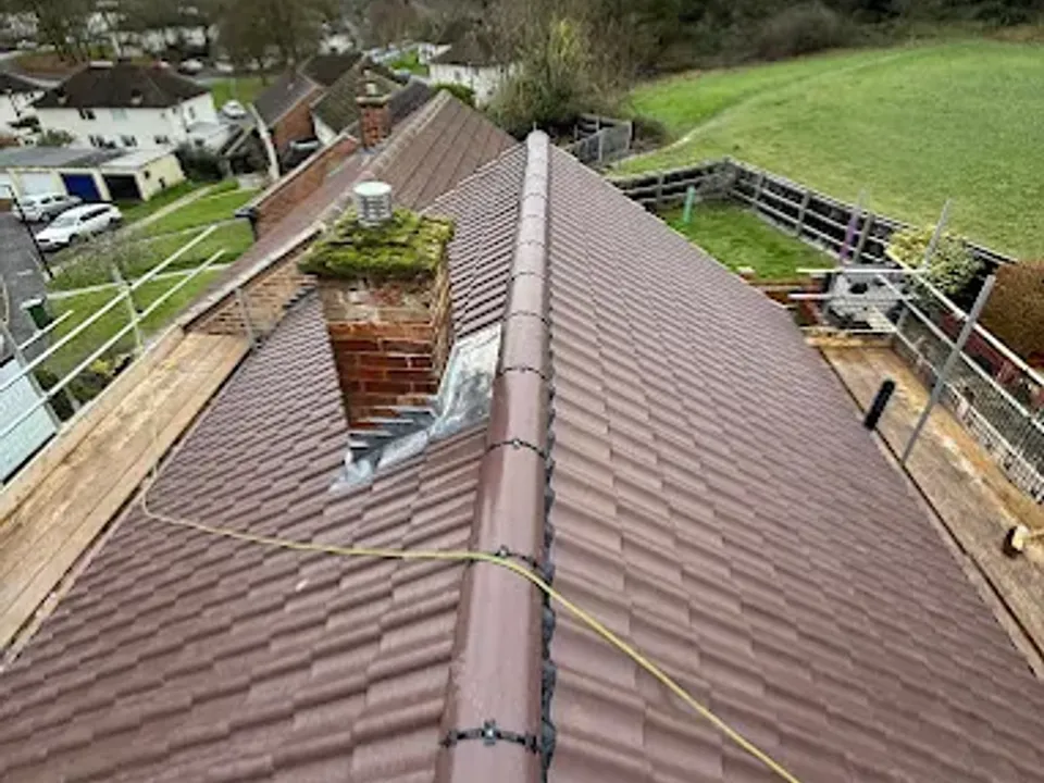 View from a finished roof across the valley with a chimney in the foreground