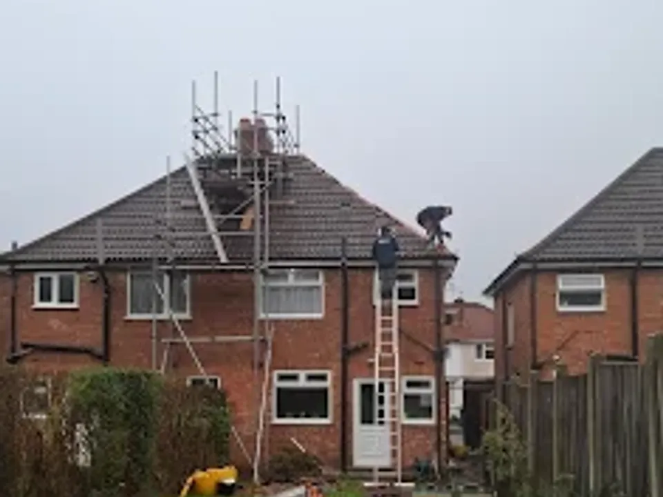 The JWJ team working from scaffolding on a semi-detached house